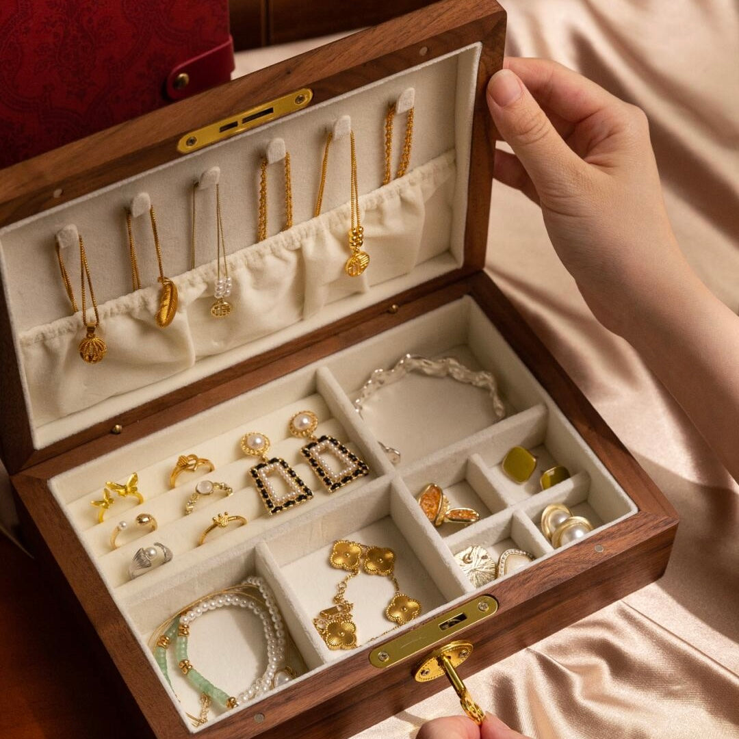 Premium black walnut jewelry box open displaying multiple compartments with velvet interior and smart storage design